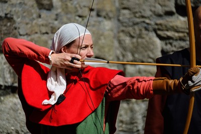 Beaumaris Medieval Festival - a lady shooting with a bow and arrow.
